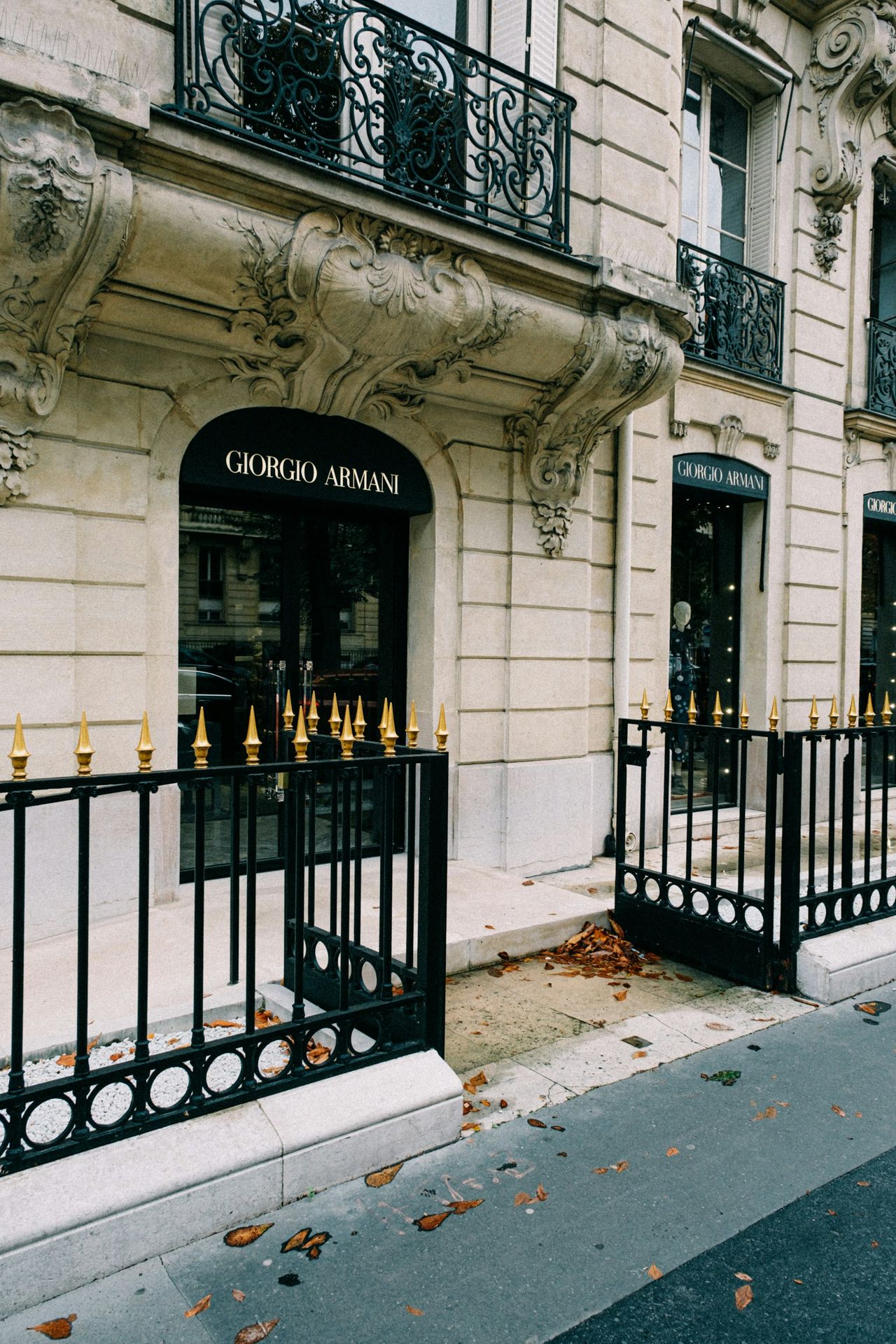 a building with a black iron fence and a black fire hydrant